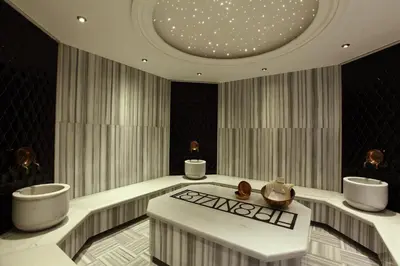 a bathroom with two sinks and a table in a room at Victory Hotel & Spa Istanbul in Istanbul
