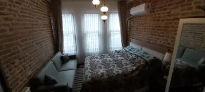 a bedroom with a bed and a brick wall at Fener sweet in Istanbul