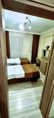 a hotel room with two beds and a piano at WİND HOTEL in Sakarya