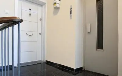 a hallway with a white door and a staircase at ELMİR SUİTES Hotel in Istanbul