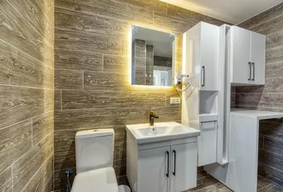 a bathroom with a toilet and a sink and a mirror at Grisverde Suites in Istanbul