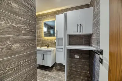 a bathroom with white cabinets and a sink at Grisverde Suites in Istanbul