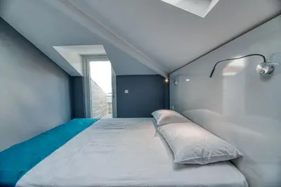 a bedroom with a large bed with a blue wall at Grisverde Suites in Istanbul