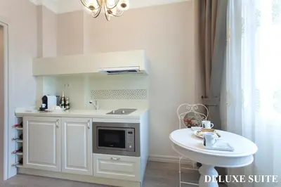 a white bathroom with a sink and a microwave at Louis Appartements Galata in Istanbul