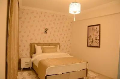 a small bedroom with a bed and a pendant light at Şar Apartment Suites in Istanbul