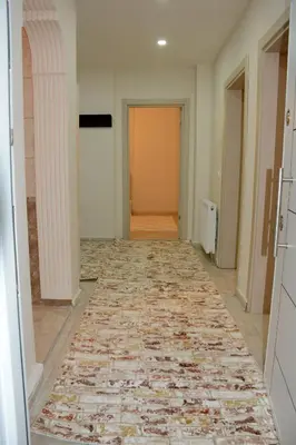 an empty hallway with a rug on the floor at Şar Apartment Suites in Istanbul
