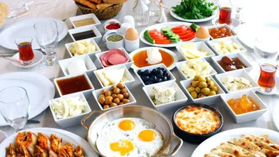 a table full of food with eggs and other foods at Şar Apartment Suites in Istanbul