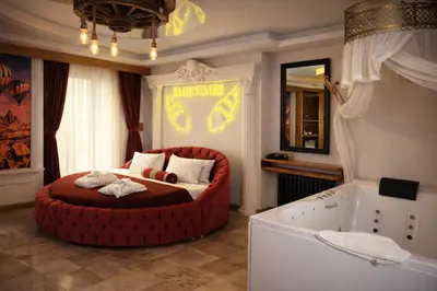 a bedroom with a large red bed and a bath tub at Emirtimes Hotel&Spa - Tuzla in Istanbul