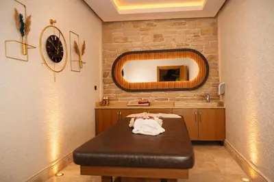 a bathroom with a table with a mirror and a sink at Emirtimes Hotel&Spa - Tuzla in Istanbul