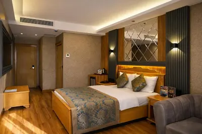 a hotel room with a bed and a chair at Emirtimes Hotel&Spa - Tuzla in Istanbul