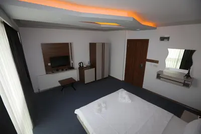 a hotel room with a bed and a television at TEVETOGLU HOTEL in Istanbul