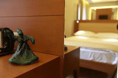 a figurine of a woman on a dresser in a bedroom at Sirkeci Park Hotel in Istanbul
