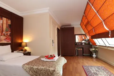 a bedroom with a bed with a bowl of fruit on it at Sirkeci Park Hotel in Istanbul
