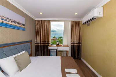 a hotel room with a bed and a window at Golden Sand Hotel in Istanbul