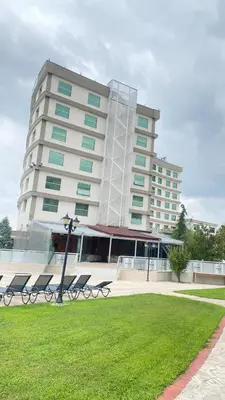 a large building with benches in front of it at The Sign Kocaeli Thermal Spa Hotel &Convention Center in Yeniköy