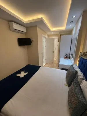 a bedroom with a large bed with a black and white bedspread at Hotel Barbarosa in Istanbul