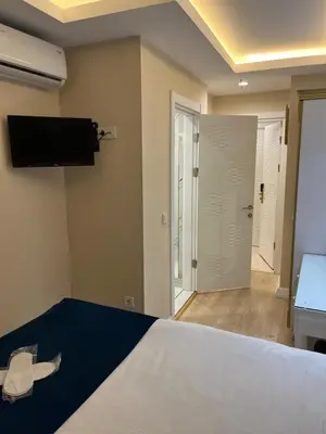 a bedroom with a bed and a flat screen tv at Hotel Barbarosa in Istanbul