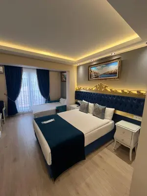 a hotel room with a large bed and a desk at Hotel Barbarosa in Istanbul