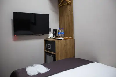 a hotel room with a bed and a flat screen tv at Jurnal Hotel in Istanbul