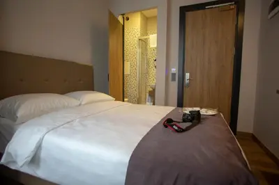 a bedroom with a large white bed with a camera on it at Jurnal Hotel in Istanbul