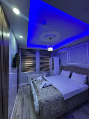 a bedroom with a large bed with a blue ceiling at Modena Hotel in Istanbul
