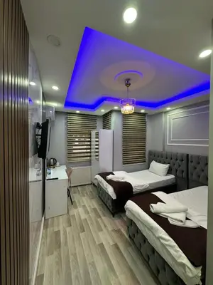 a room with two beds and a blue ceiling at Modena Hotel in Istanbul