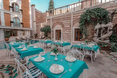 a group of tables and chairs in front of a building at Seven Hills Palace & Spa in Istanbul