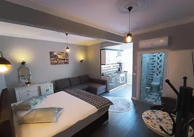 a bedroom with a bed and a living room at Little Palace Blue Apartment in Istanbul