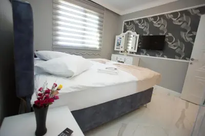 a bedroom with a large bed and a television at Little Palace Blue Apartment in Istanbul