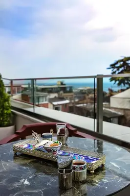 a table with a tray of food on a balcony at Obelisk Hotel & Suites in Istanbul