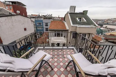 a balcony with chairs and a view of a city at Calanthe Residence in Istanbul
