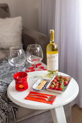 a white table with a bottle of wine and wine glasses at Sadaret Suites-Old City Sultanahmet in Istanbul