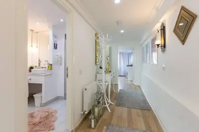 a white hallway with a sink and a bathroom at Sadaret Suites-Old City Sultanahmet in Istanbul