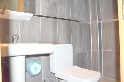 a bathroom with a white toilet and a sink at Elite Hotel City Center Saray Bed and Breakfast in Saray