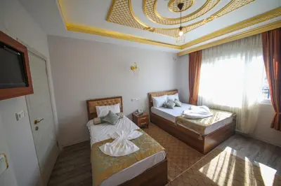 a hotel room with two beds and a television at DELBAB HOTEL in Istanbul