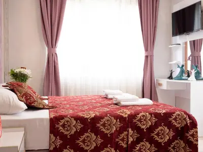 a bedroom with a red bed with towels on it at The Zanadu İstanbul in Istanbul