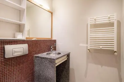 a bathroom with a sink and a mirror at Mayer Tatarbey Apartments in Istanbul