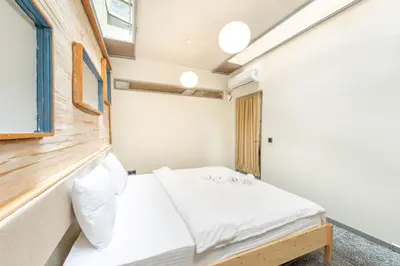 a small bedroom with a bed and a window at Mayer Tatarbey Apartments in Istanbul