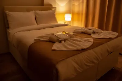 a large bed with white sheets and towels on it at Reggae in Istanbul