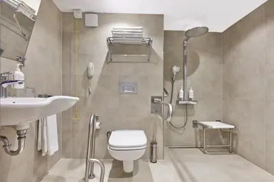 a bathroom with a shower and a toilet and a sink at Konak Hotel Taksim in Istanbul