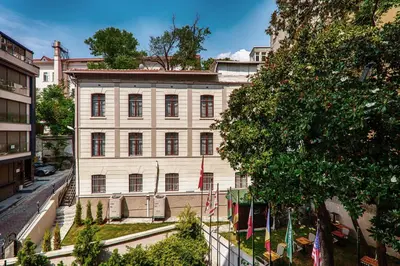 a large white building with flags in front of it at Element Garden in Istanbul