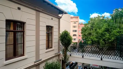 a building with two windows and a tree next to it at Element Garden in Istanbul