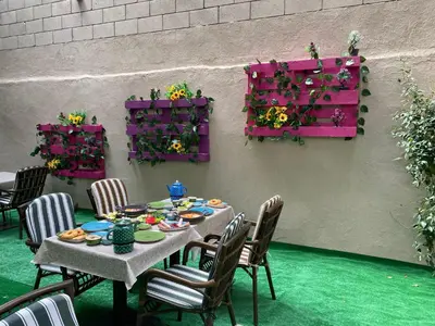 a table with chairs and flowers on a patio at Element Garden in Istanbul