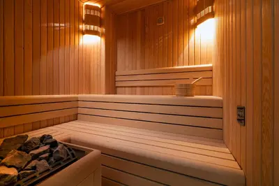 a sauna with wood paneled walls and a tub at Gleam Bomonti Hotel in Istanbul