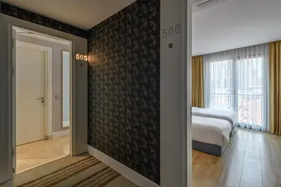 a room with a bedroom with a bed and a window at Gleam Bomonti Hotel in Istanbul