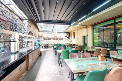 a restaurant with tables and chairs and a stone wall at Valens Hotel Downtown in Istanbul