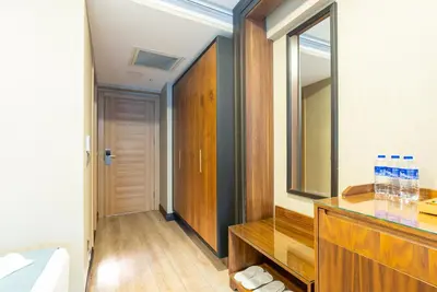 a bathroom with a wooden dresser and a mirror at Valens Hotel Downtown in Istanbul