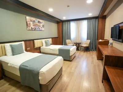 a hotel room with two beds and a television at Valens Hotel Downtown in Istanbul