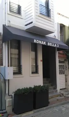 a white building with a blue awning on it at KONAK BELLA 3 in Istanbul