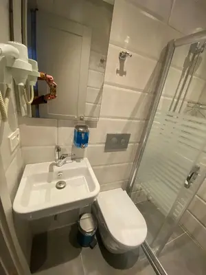 a bathroom with a toilet and a sink and a shower at KONAK BELLA 3 in Istanbul